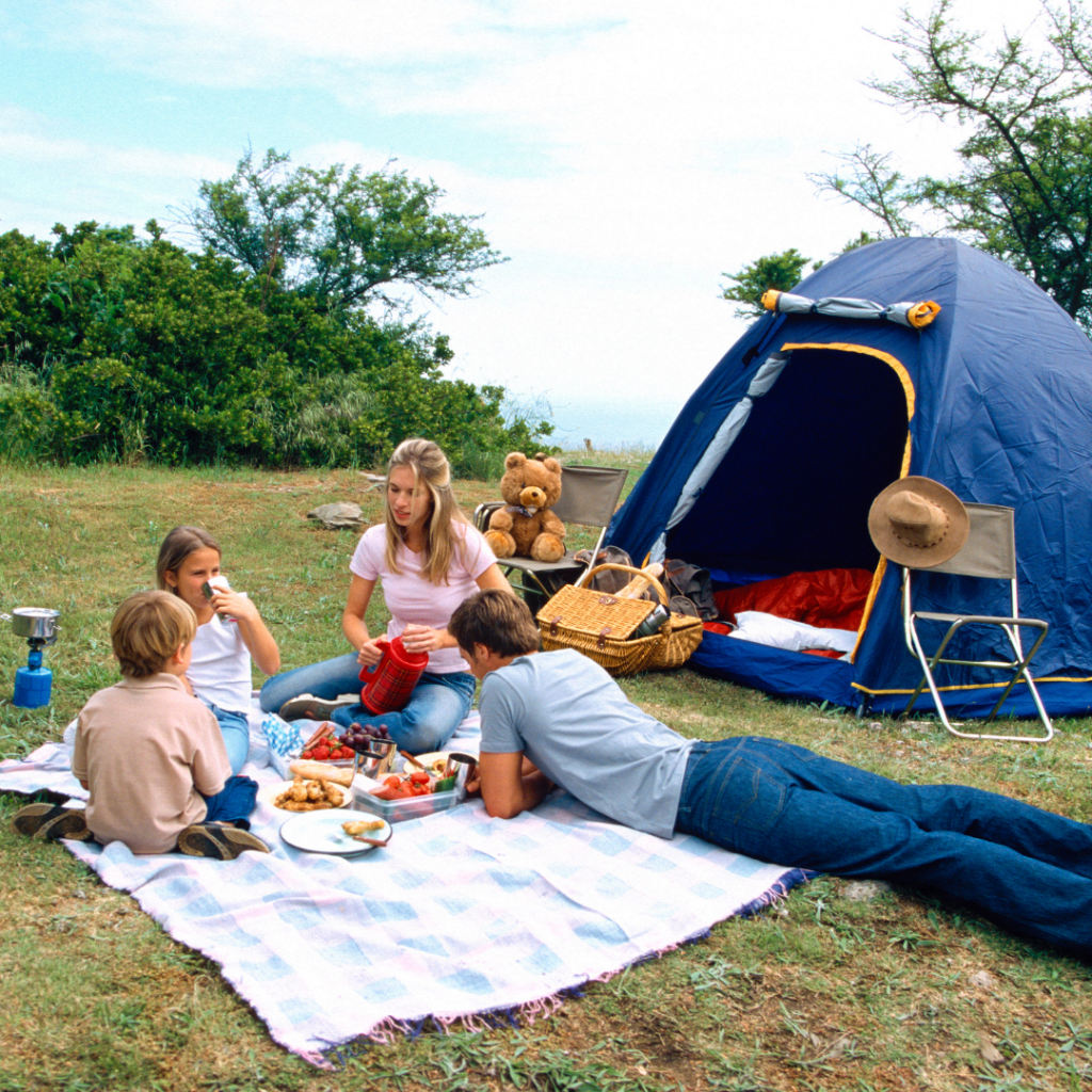 family camping in a blue tent